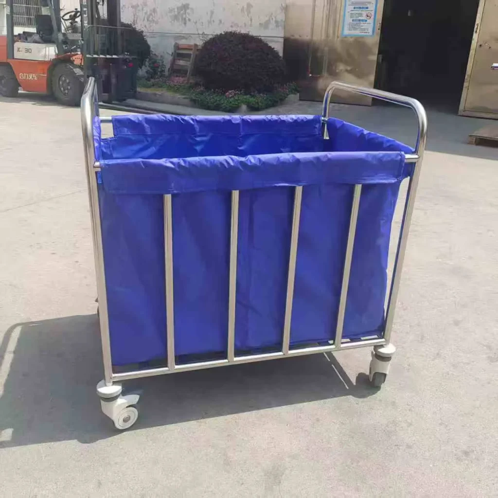 Blue fabric cart with metal frame and wheels, used for storage and transport, positioned outdoors on concrete surface.