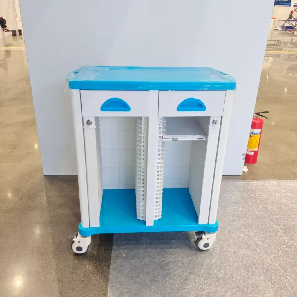 Medical trolley with blue and white design in a hospital setting, featuring two compartments with numbered slots and wheels.