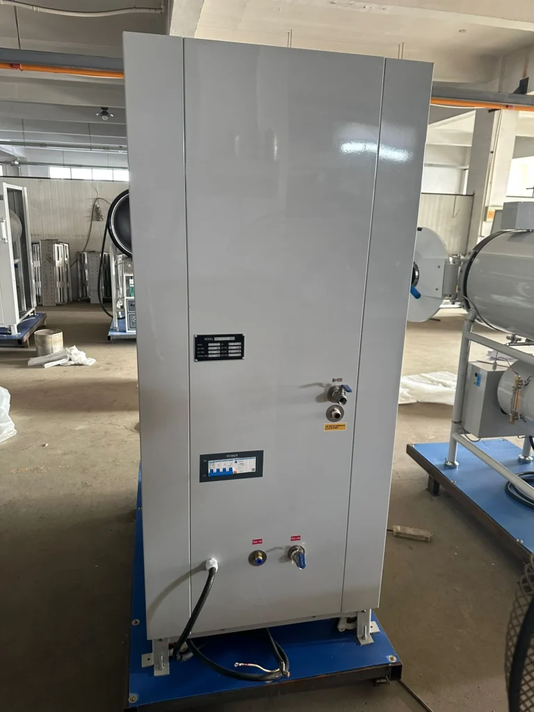 An industrial control panel with cables and switches in a factory environment, mounted on a blue base.