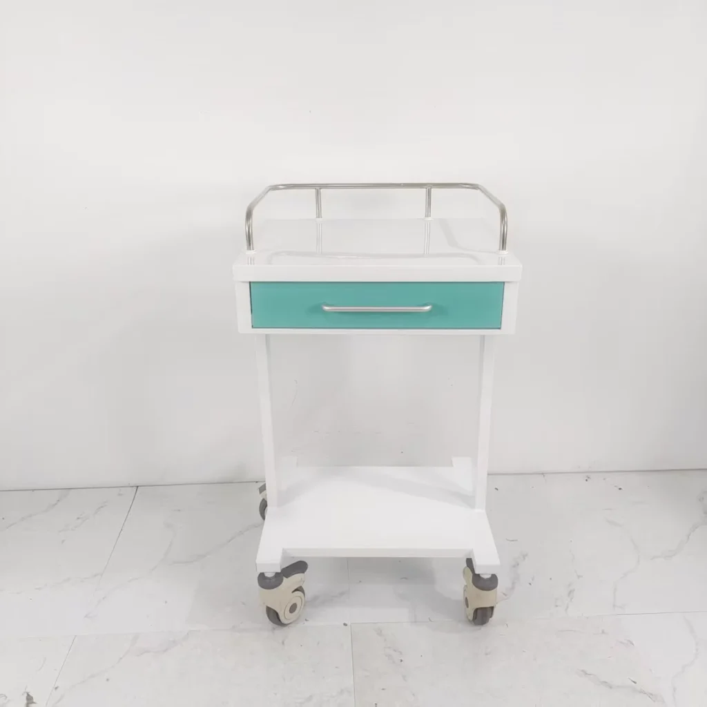 White medical trolley on wheels with a turquoise drawer and metal handle, placed against a plain background.