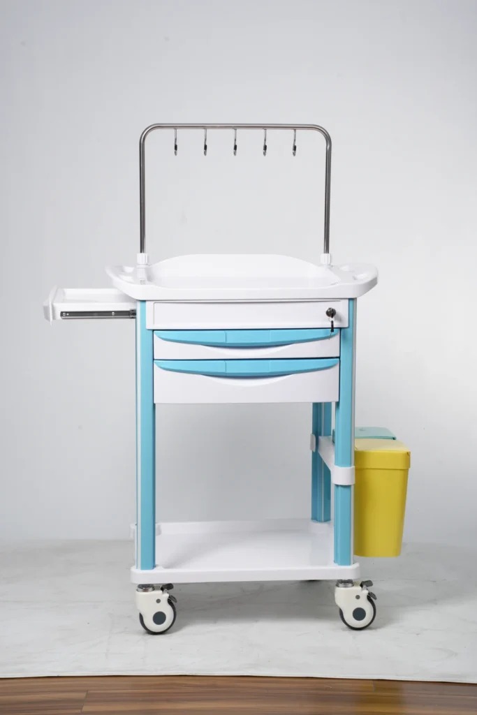 A blue and white medical trolley with two drawers, a yellow waste bin, caster wheels, and hooks for hanging items.