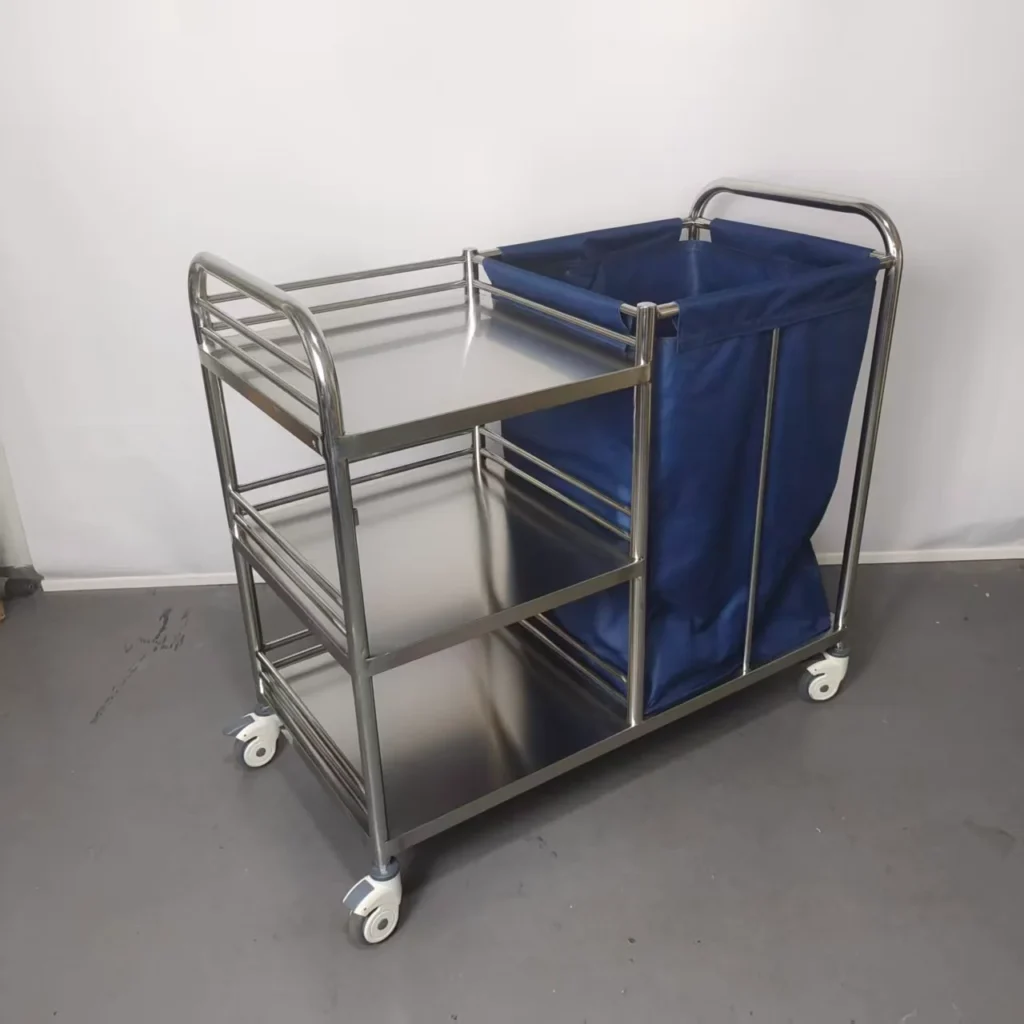 Stainless steel laundry cart featuring a blue fabric bag and three metal shelves, equipped with caster wheels for mobility.