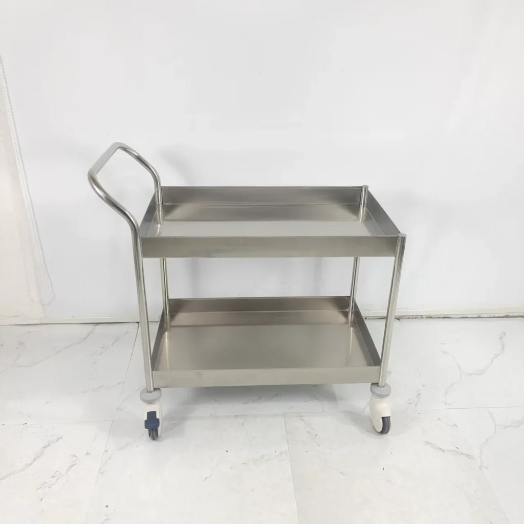 Two-tier stainless steel serving cart with wheels and handle against a white background.