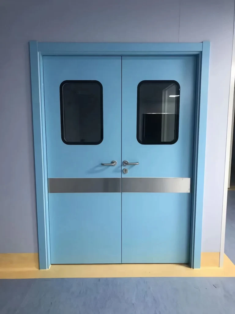 Blue hospital swing doors with rectangular window panels, metallic handles, and a dual-tone floor design.