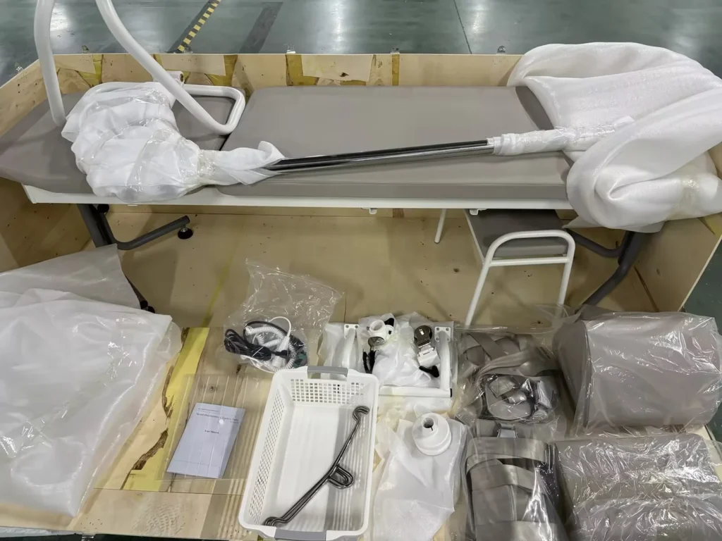 Various medical equipment pieces disassembled and wrapped in protective packaging, laid out on a wooden base.