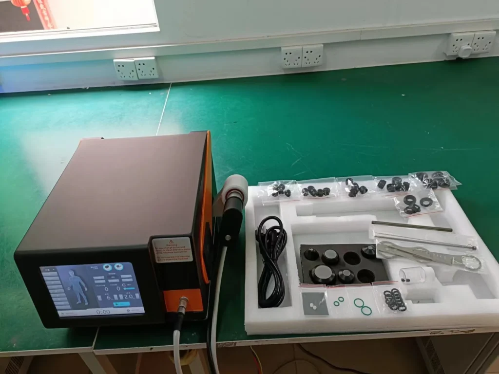 Medical equipment with a digital display next to organized accessories on a green table.