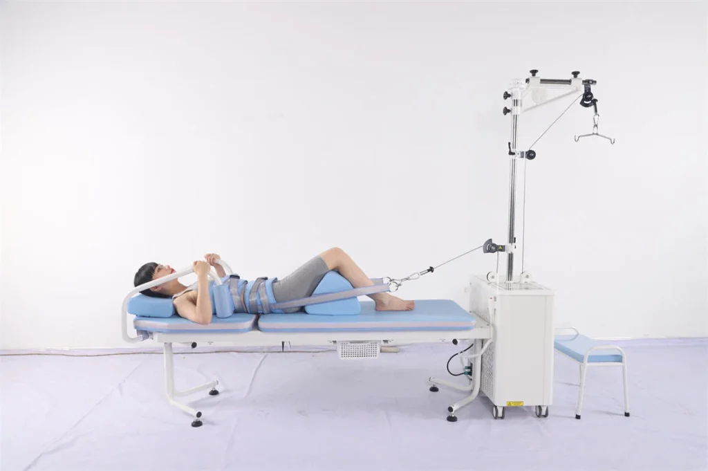 Individual lying on a physical therapy traction table with support straps and a mechanical traction machine.