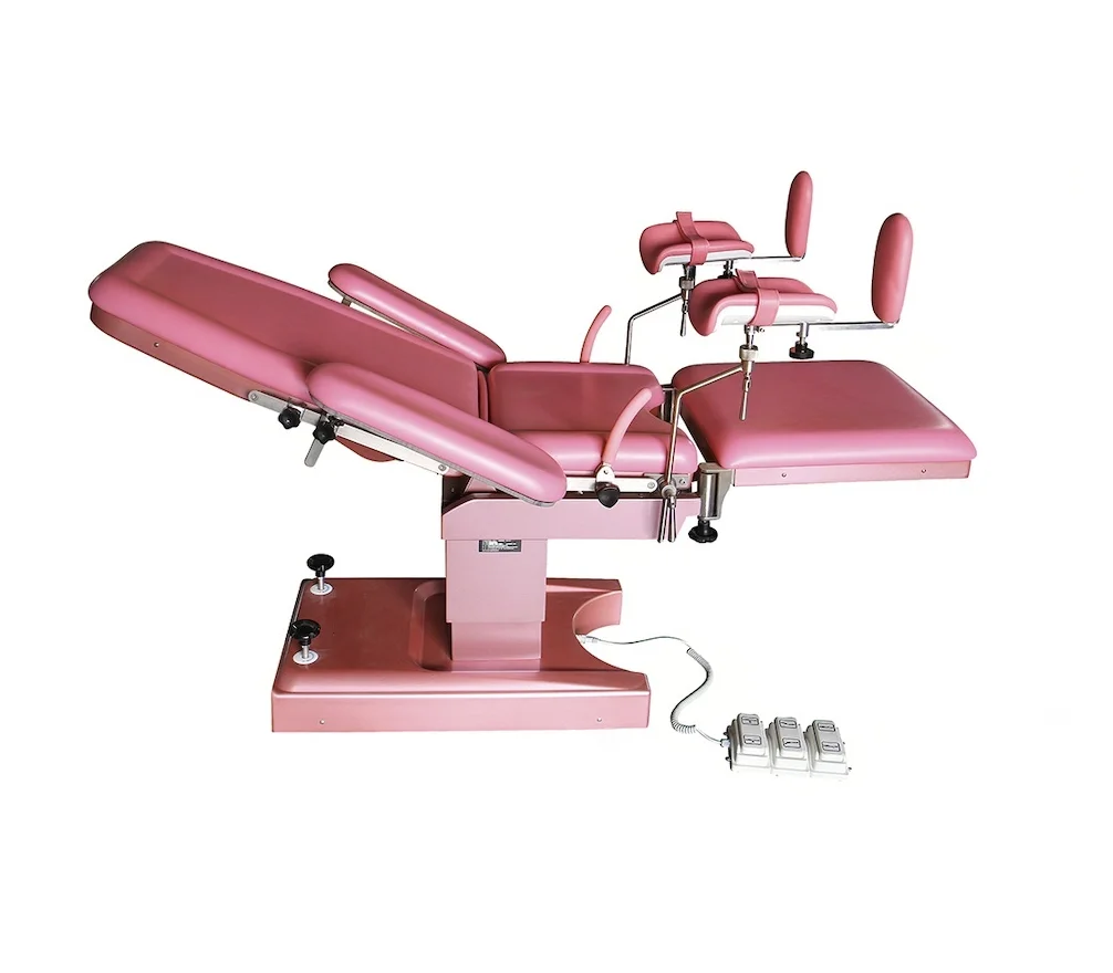 Pink medical examination chair with adjustable sections and foot pedals on a white background.