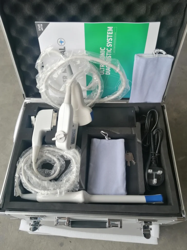 Ultrasonic diagnostic system kit with components neatly arranged in a carrying case, including probes, cables, and a manual.