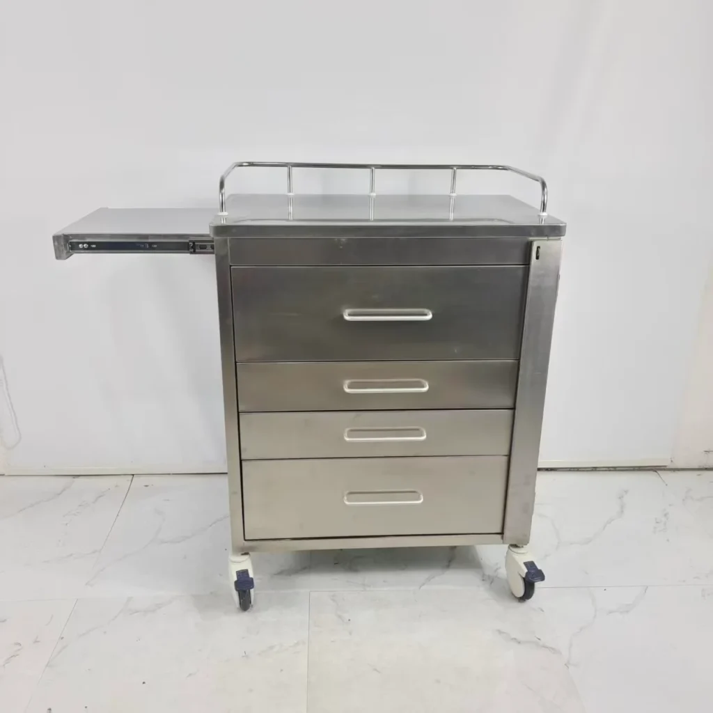 Stainless steel medical trolley featuring four drawers, caster wheels, and a side extension on a white background.