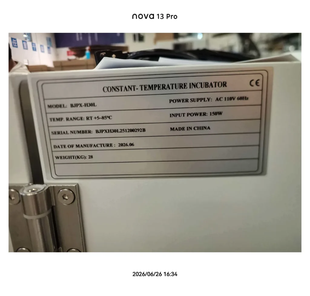 Label on a constant-temperature incubator showing model number BJPX-H30L, temperature range RT +5–85°C, power supply AC 110V 60Hz, input power 150W, and weight 28kg. Manufactured in China, dated 2026.06.