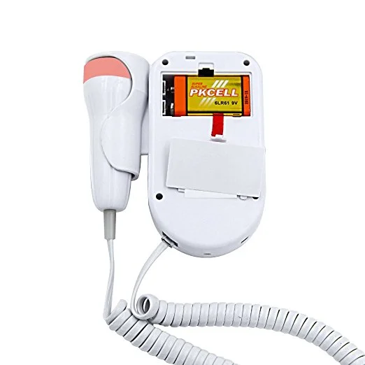 A handheld device with a coiled white cable, open to expose a PKCELL 9V battery in the rear compartment.