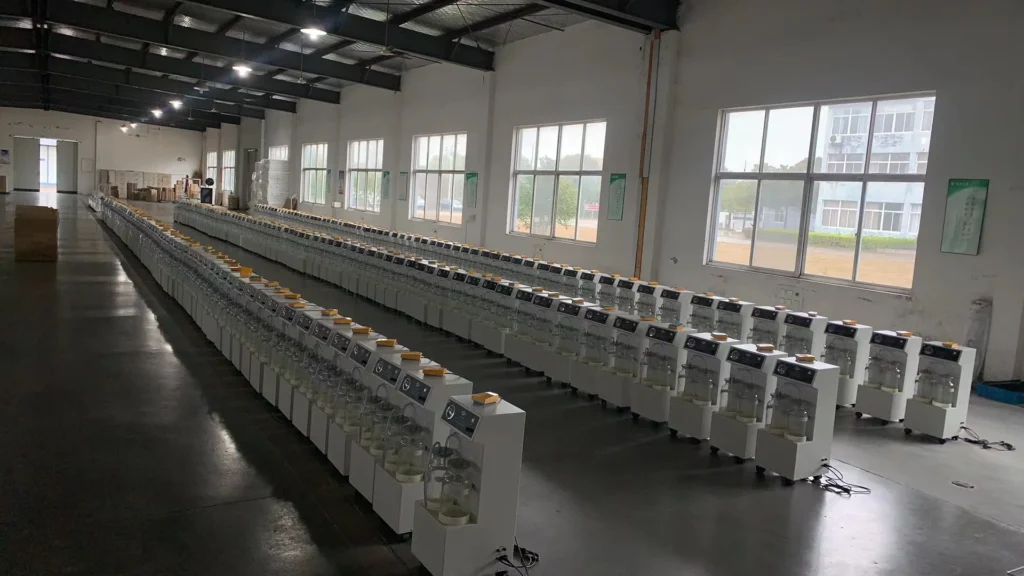Rows of laboratory equipment with transparent chambers and control panels arranged in a well-lit storage facility.