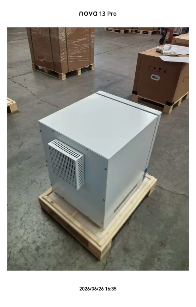 White industrial unit with ventilation panel placed on a wooden pallet in a warehouse setting.