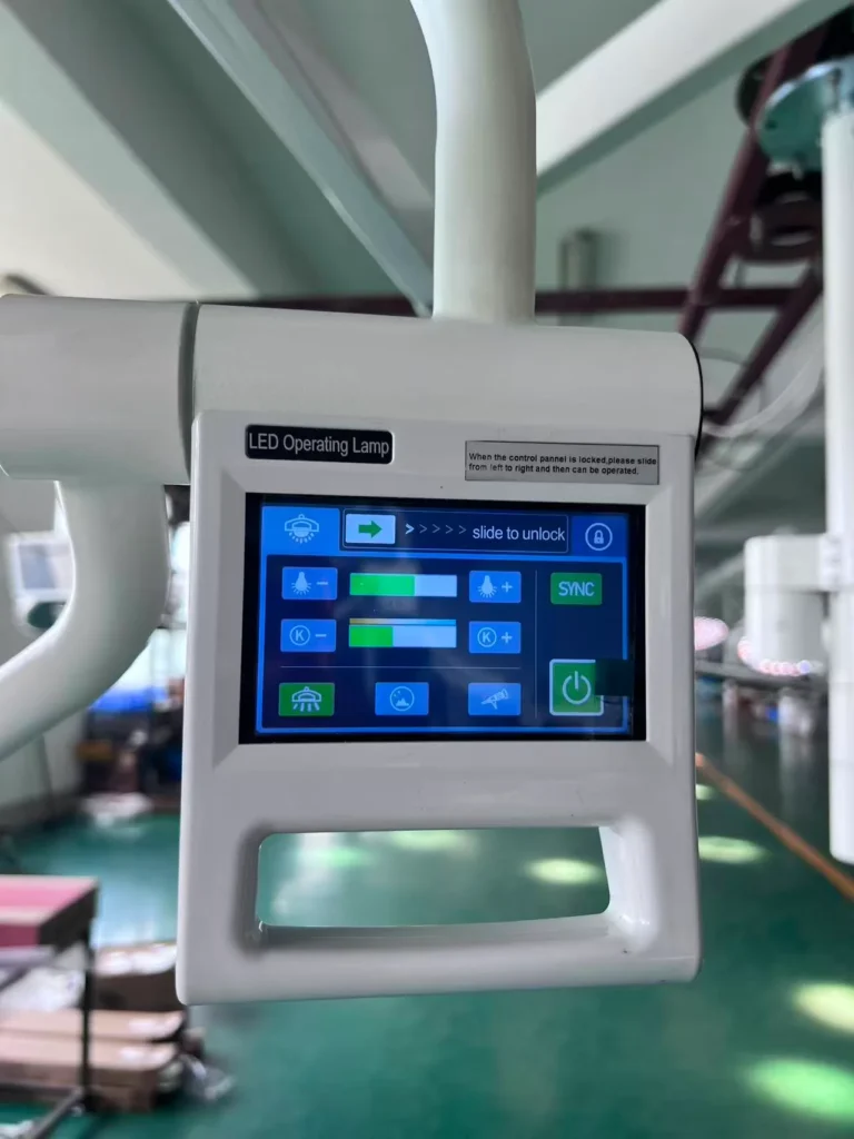 Close-up of a LED operating lamp touchscreen control panel with various icons and controls in a well-lit industrial setting.