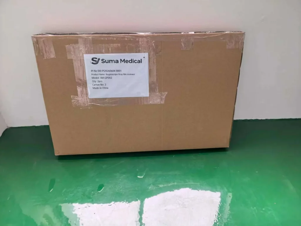 A cardboard shipping box labeled with Suma Medical branding, containing product information including model SM-GP002 and made in China.