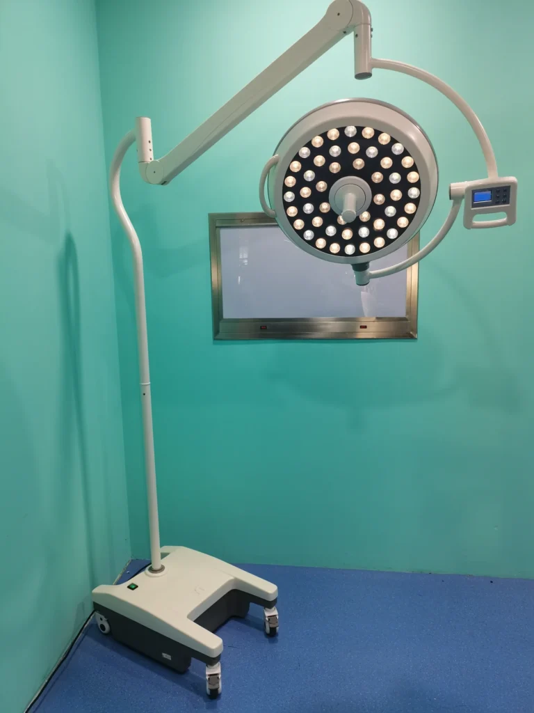 Portable surgical LED lighting system with adjustable arm and multiple light bulbs, set in a turquoise-walled room with blue flooring.