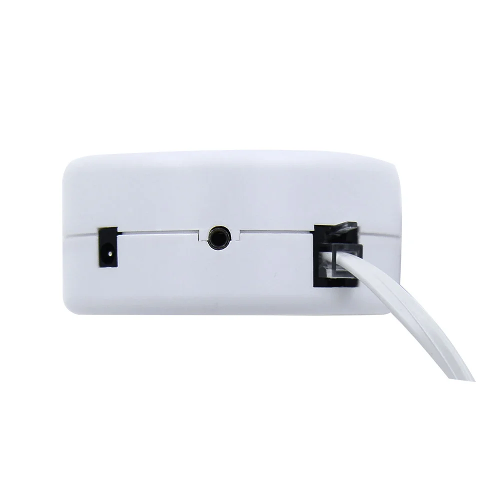Back view of a white electronic device featuring a central port and an attached cable on the right side.