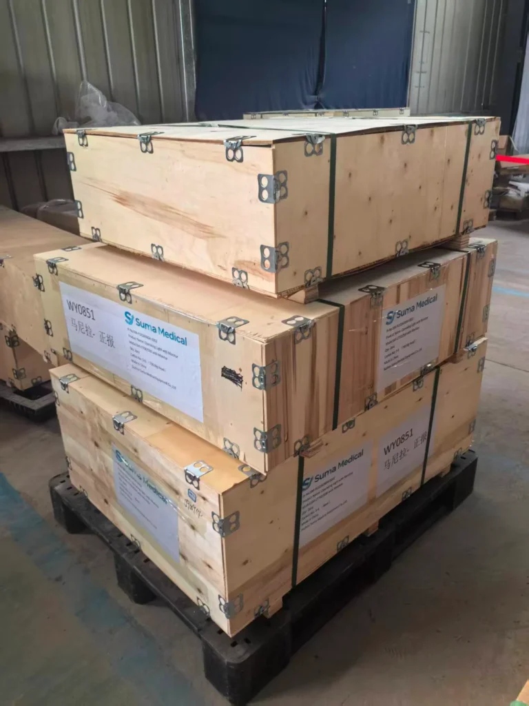 Stacked wooden shipment crates labeled for medical supplies by Suma Medical, secured with metal fittings and placed on a black pallet.