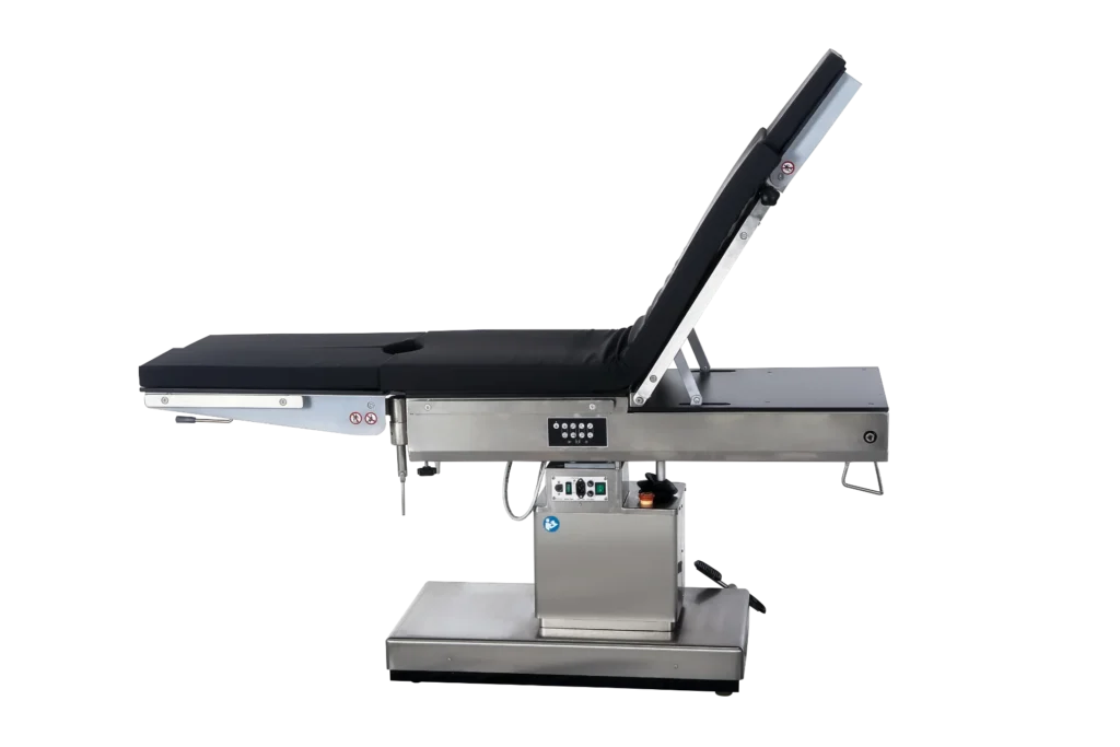 Adjustable surgical operating table with a metallic base, black cushioned surface, and reclining backrest, set against a black background.