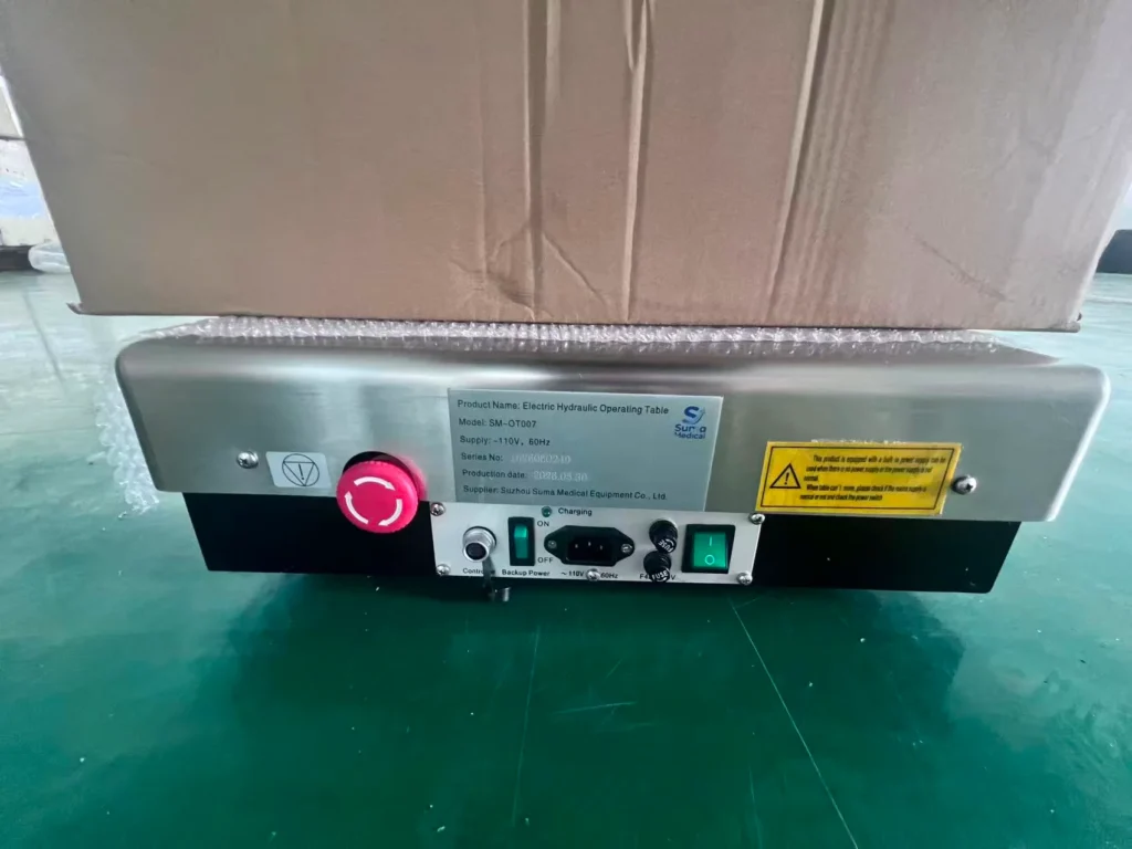 Control panel of an electric hydraulic operating table with visible switches, warning labels, and product specifications.
