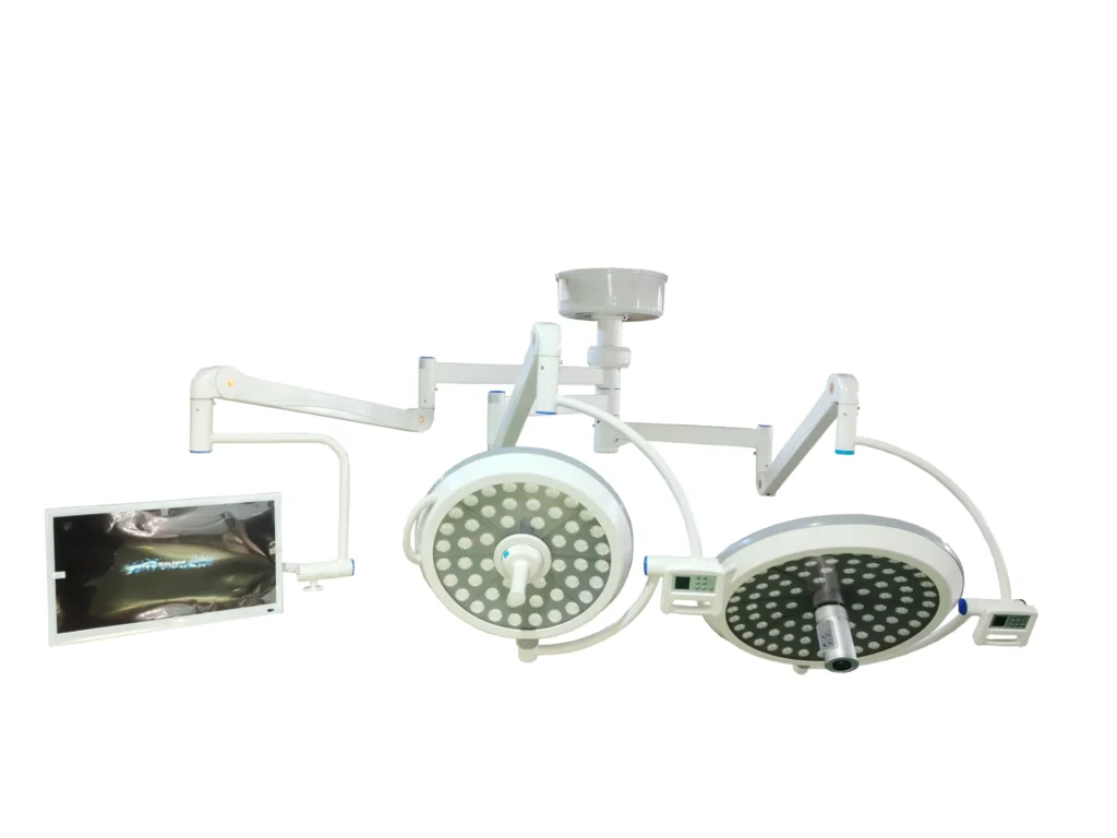 Overhead surgical LED lights featuring dual circular light panels and an attached monitor for medical procedures.