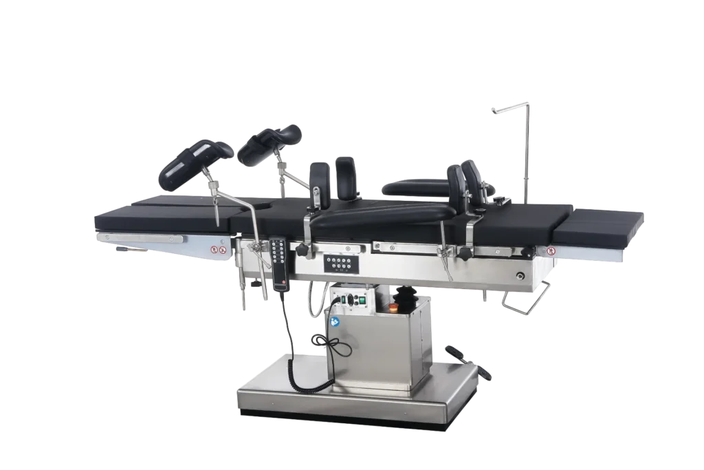 A modern surgical operating table in black and silver with adjustable components, armrests, and electronic control panel.