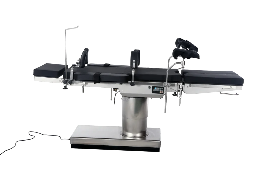 A modern surgical operating table with adjustable sections and a sleek metallic design, including padded black cushions and attached electronic controls.